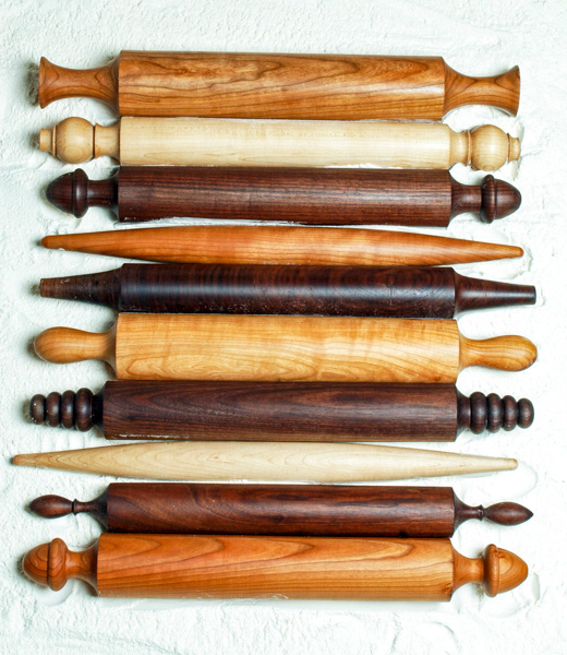 A row of handcrafted rolling pins.