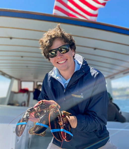 Someone holding up a freshly caught lobster