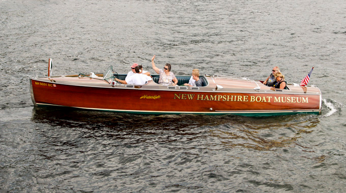 People sailing aboard a 1928 Hacker-Craft replica