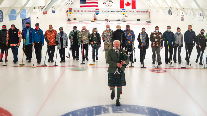A bagpipe player performs to kick off a Belfast Curling Club tournament
