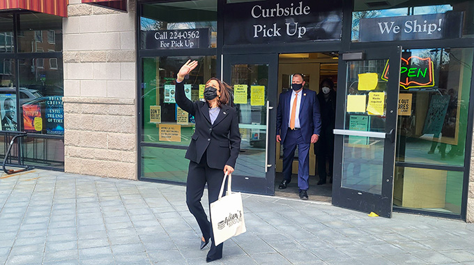 Kamala Harris waving as she leaves Gibson's Bookstore.
