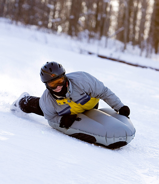 Rocketing downhill on an inflatable airboard is an out-of-the-ordinary way to boost your adrenaline. | Photo courtesy Smugglers’ Notch Vermont