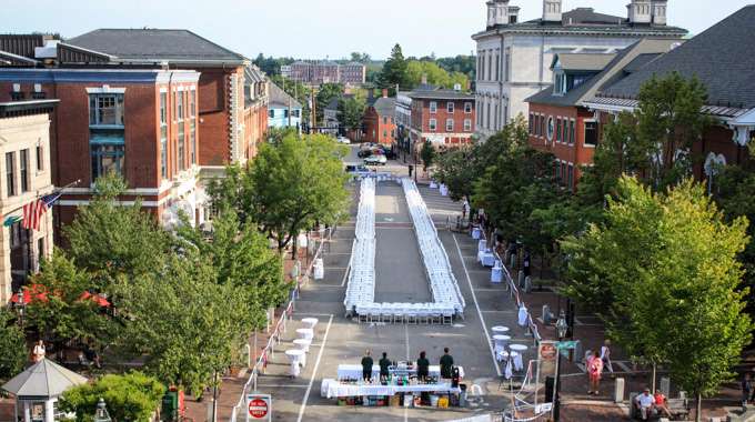 Chairs blocking off a section of the street for the community dinner