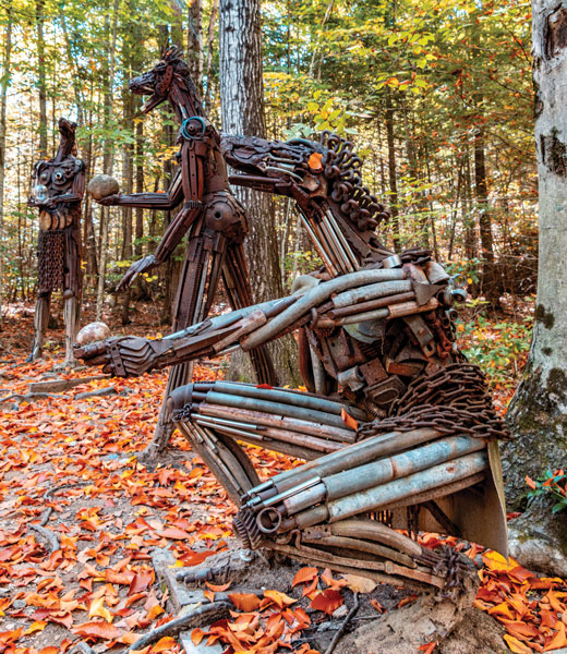 Trio of animal-like sculptures in the woods.