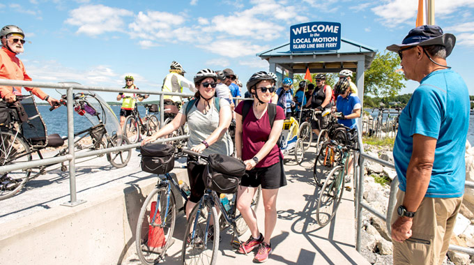 Cyclists  waiting with their bikes for the ferry to arrive