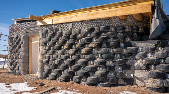Stacks of tires ready to be plastered for an Earthship wall
