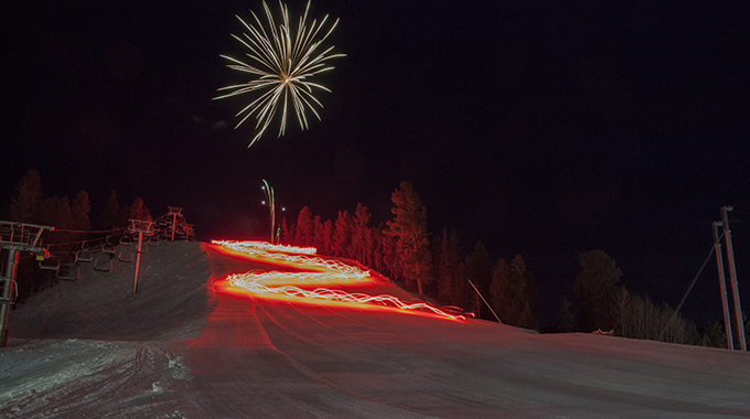 Fireworks illuminating the sky during the Red River Torchlight Parade