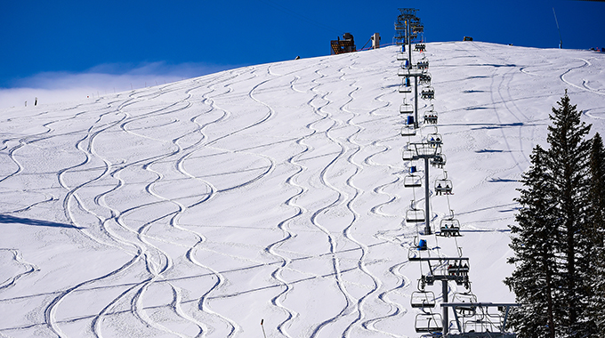 Skiiers ascend Sierra Blanca via the Ski Apache Lifts