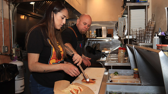 Adrianna Merrick, owner of Don Felix Café, works in the kitchen.