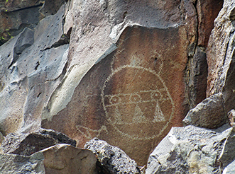 Katsina-like faces bedeck the walls, representing deities in pueblo religion. (Notice the shorebird at lower left.)