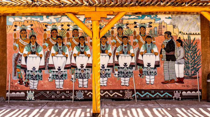 A mural showing a group of Pueblo people at the Indian Pueblo Cultural Center.
