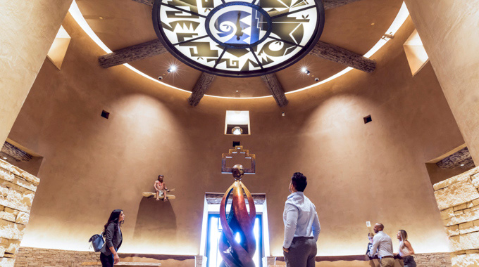 Visitors looking up at the eagle motif hanging over the Hotel Chaco lobby