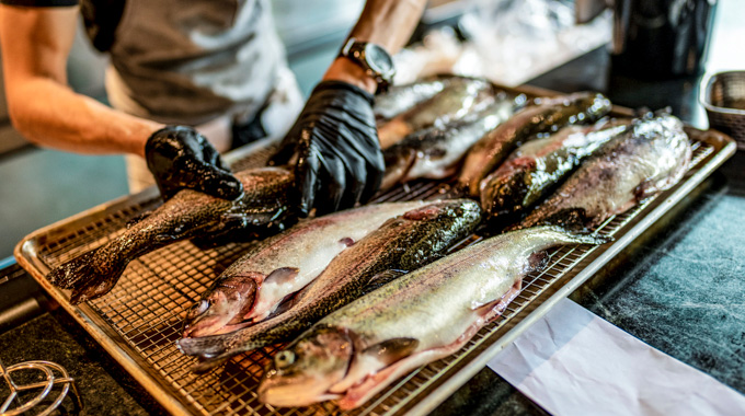A tray of sea bass being prepared.
