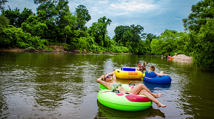 People and a dog tubing on the Bogue Chitto River.