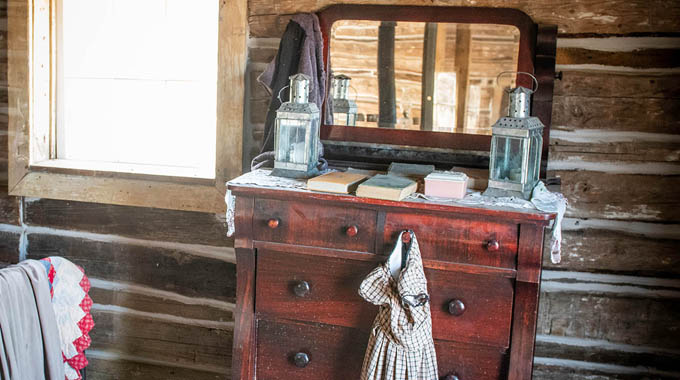 The simply furnished interior of the cabin where Butch Cassidy grew up. | Photo by Jad Davenport