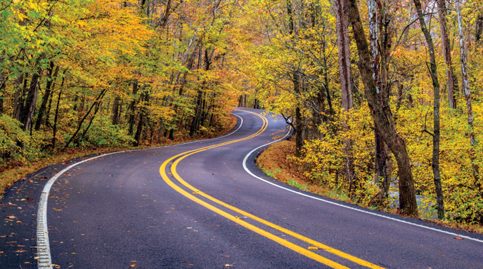 Curving roads cut through dense forests across the Ozark region. | Photo by Joe Sparks/stock.adobe.com