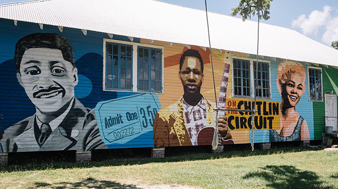 A vibrant mural helps tell the story of the 100 Men Hall in Bay St. Louis. | Photo courtesy Coastal Mississippi