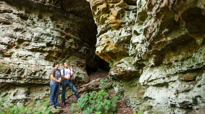 Pair of hikers pausing to look at giant rock formations