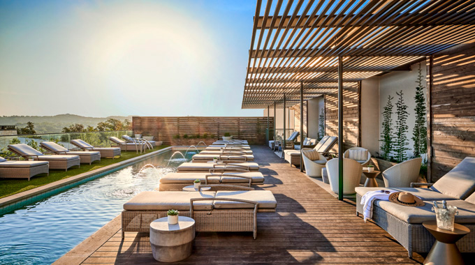 Lounge chairs surrounding the pool at Omni Barton Creek Resort Spa