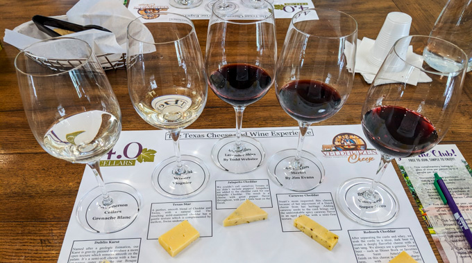 Five glasses of wine with cheese pairings