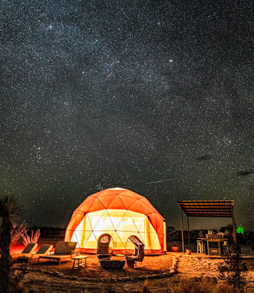 StarStruck Glamping's bubble tent at night.