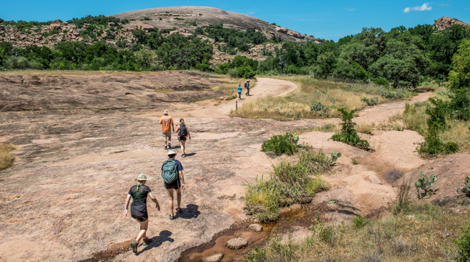 Hikers on the Enchanted Rock hiking trail.