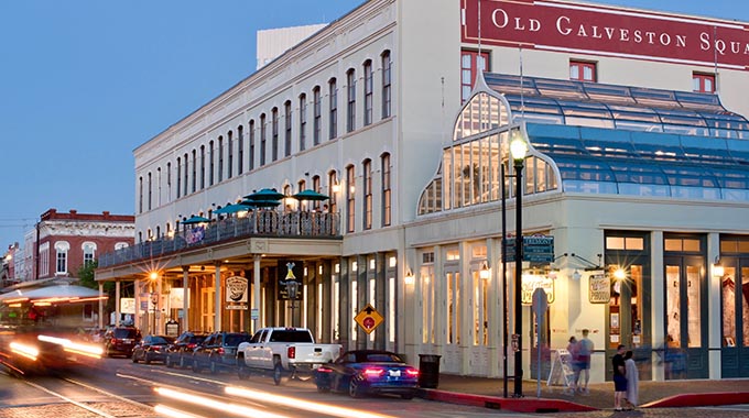Streaks of trolley headlights illuminate the shops, galleries and restaurants at Old Galveston Square. |