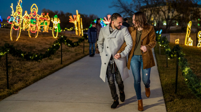 A couple strolling along the Marble Falls Walkway of Lights
