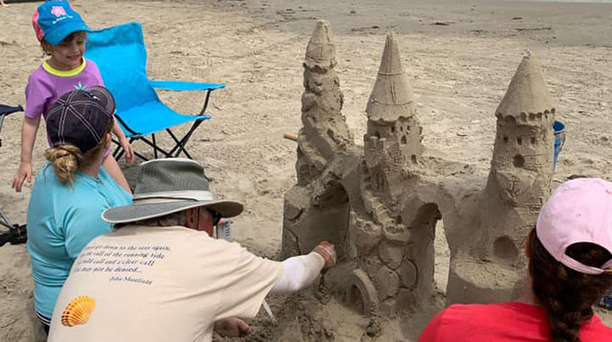 Port Aransas Sandcastle Guy's Mark Landrum teaches beachgoers the art of creating an eye-catching sandcastle. | Photo courtesy Port Aransas Sandcastle Guy/Mark Landrum