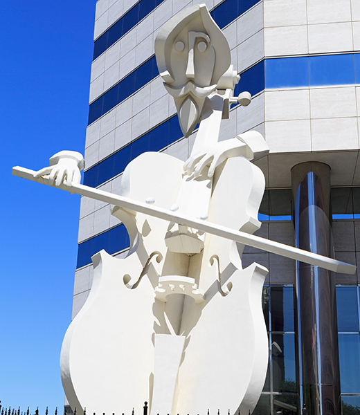 Spot the 36-foot concrete sculpture Virtuoso, by artist David Adickes, in downtown Houston. | Photo by Richard Cummins/Alamy Stock Photo