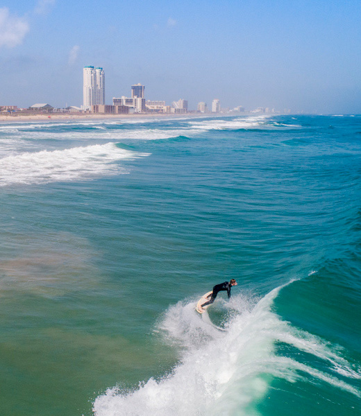 A surfer on the water off South Padre Island