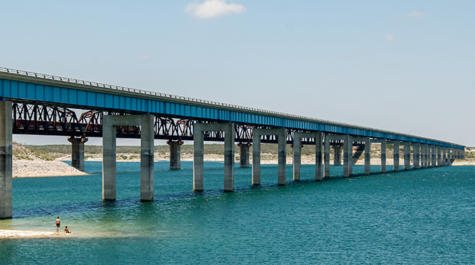 A bridge stretches across the Amistad Reservoir, a man-made lake that's part of the Amistad National Recreation Area in Del Rio.  | Photo by Mathew Risley/stock.adobe.com