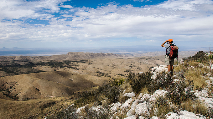 A hiker looks on from the top of Lost Peak, on the north end of the Guadalupe Mountains National Park in Salt Flat. | Photo by Donna Ikenberry/Art Directors/Alamy Stock Photo