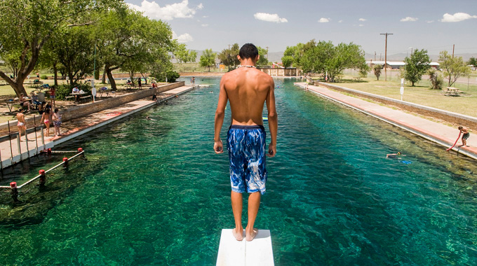 Guest looking down from a diving board in Balmorhea State Park