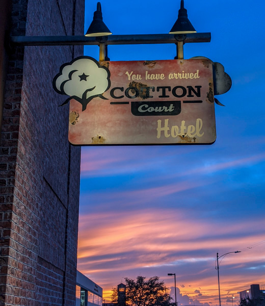 Sign welcoming guests to the Cotton Court Hotel