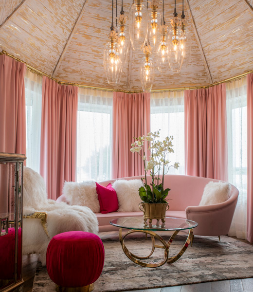 Pink drapery and furniture accent the Hey Sugar Suite at Hotel Lucy