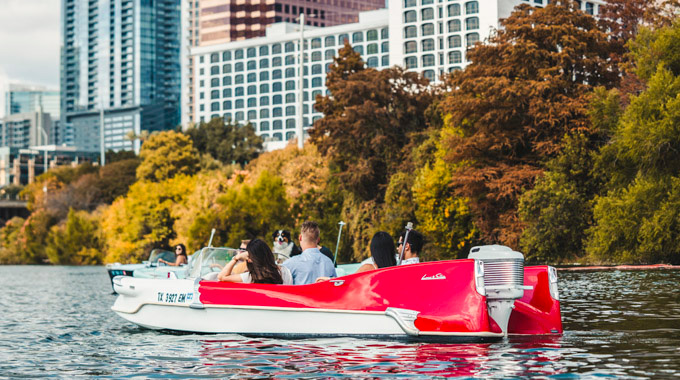 People cruising in a vintage boat