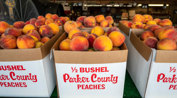 Cardboard boxes with half bushles of Parker County peaches