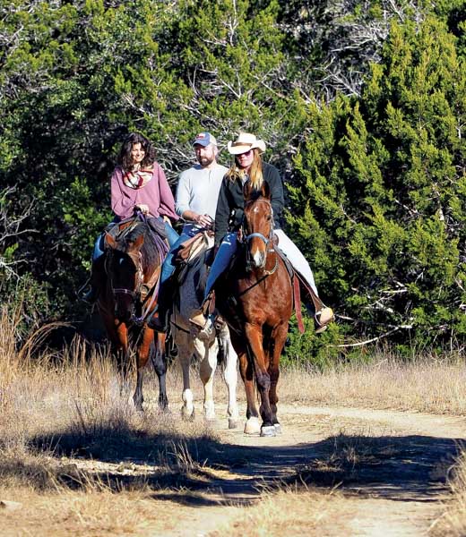 A trio of people riding horseback