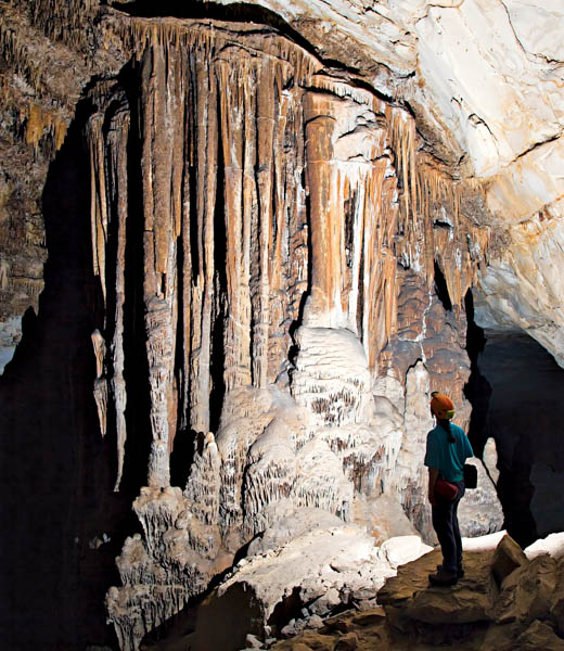 Person looking up at formations inside Kickapoo Cavern