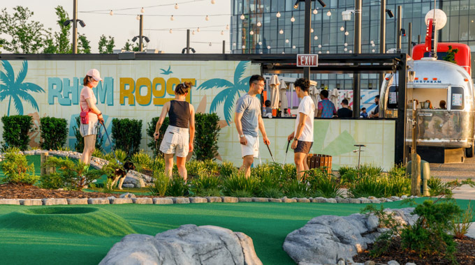 A group of 4 mini-golf players at Perch Putt