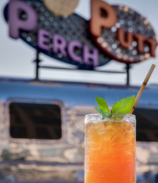 A cocktail in a glass tiki cup from Rhum Roost