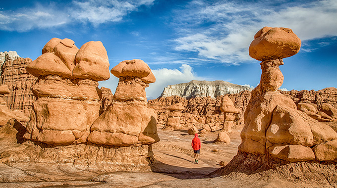 A hiker walks among the hoodoos at Utah’s Goblin Valley State Park.