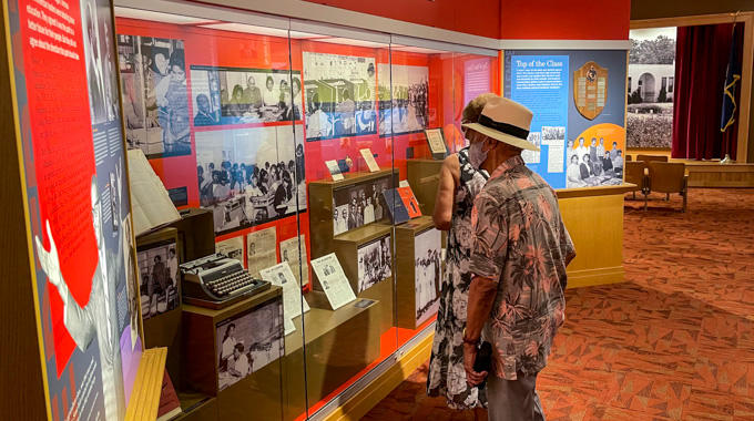 Visitors viewing an exhibit with images of former students at the Princess Anne County Training School/Union Kempsville High School Museum