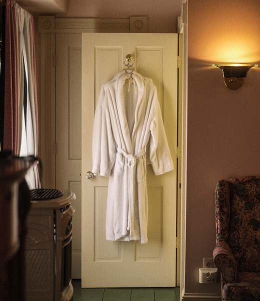 Robes hanging from a door in a guest room at the Garden and Sea Inn