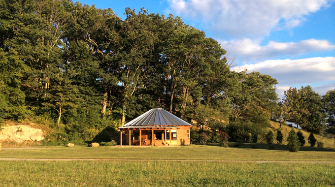 A luxury yurt in a field at Rose River Farm