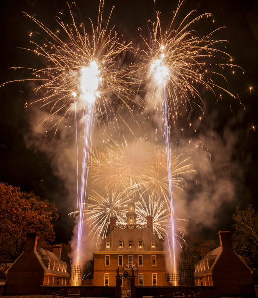 Fireworks frame Colonial Williamsburg during the Grand Illumination