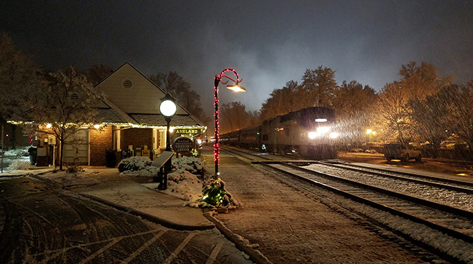 An Amtrak train passing through Ashland Station
