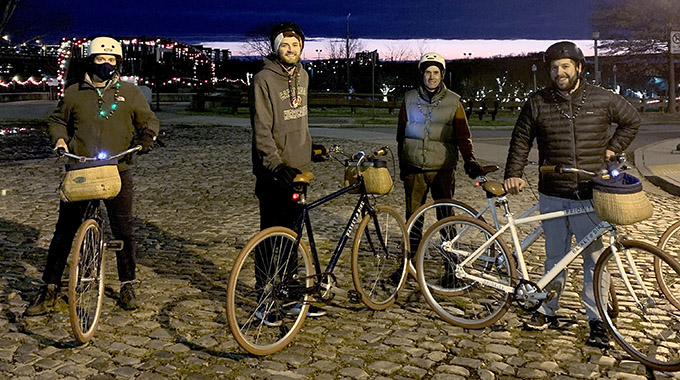Four people standing with their bicycles