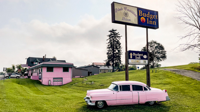 Exterior of Pink Cadillac Diner, with an aptly colored car parked nearby.